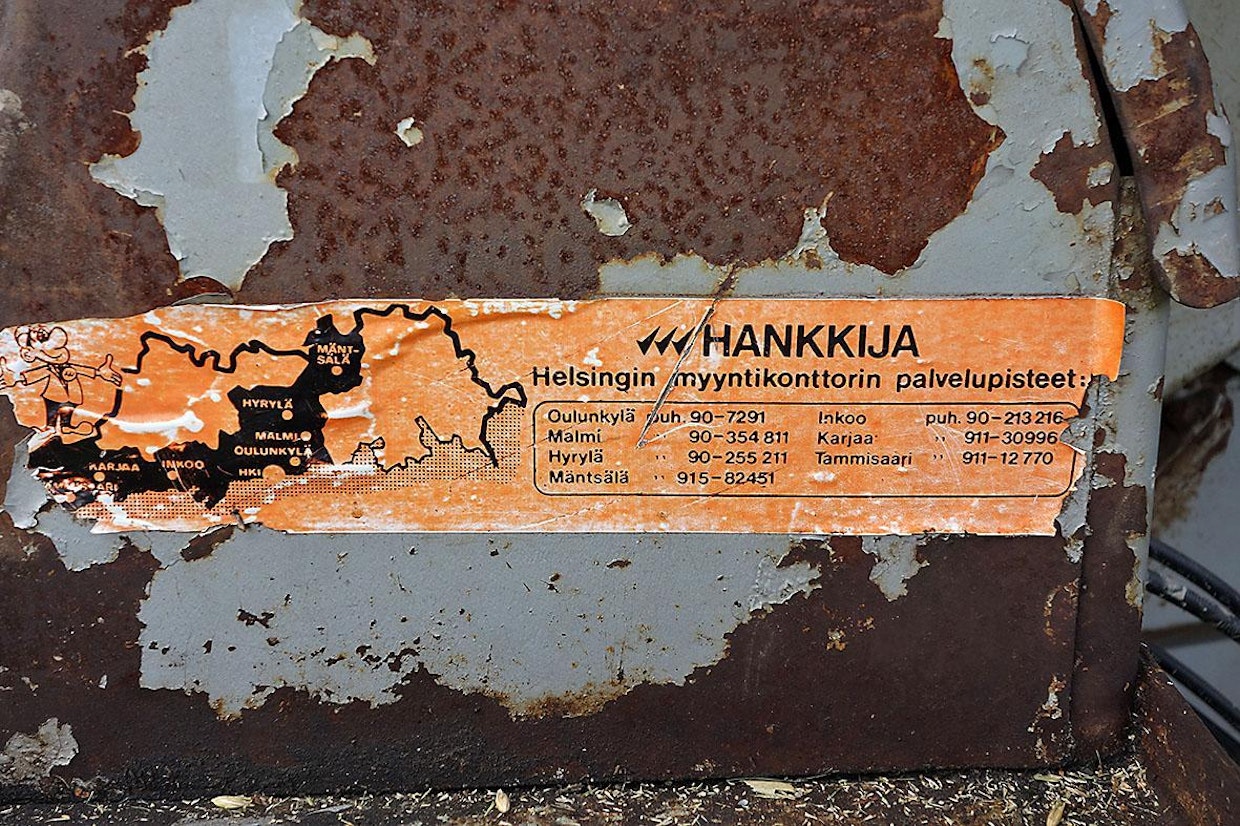 Ilmeisesti tämä puimuri on ollut koko työaikansa Uudellamaalla. Jossain vaiheessa on Hankkijan huolto liimannut tarransa koneen kylkeen muistuttamaan puhelinnumeroistaan.