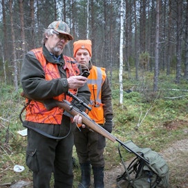 Osmo Virtanen ja kahdeksasluokkalainen Oskari Nissinen seuraavat passipaikalta, missä hirvikoira on liikkeellä.