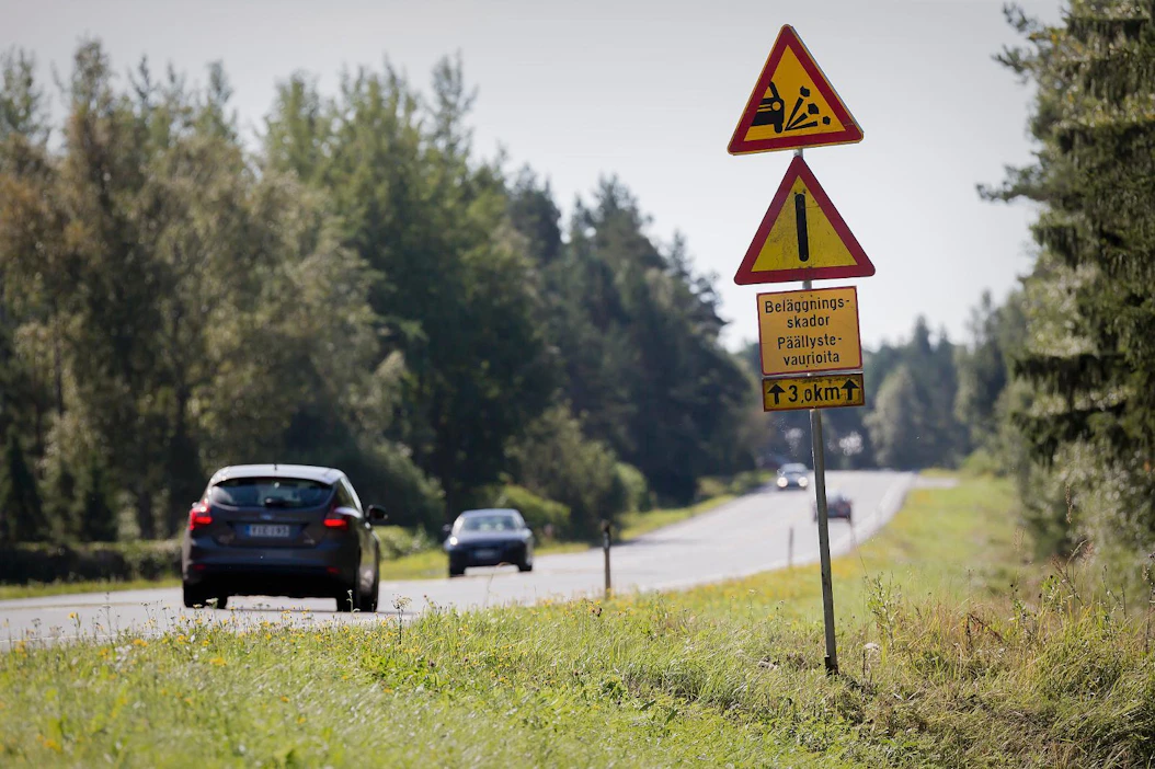 Liikennemerkit varoittavat autoilijoita 8-tiellä vaurioituneesta päällysteestä. Tie korjattiin alkukesällä.