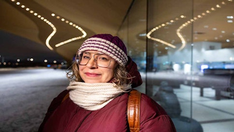 Henkilö seisoo keskustakirjasto Oodin edessä.