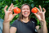 Elina Salminen esittelee ylpeänä tuoreita luonnonvalossa kypsyneitä tomaatteja.