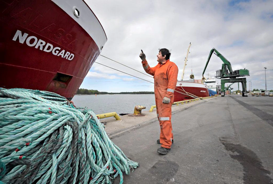 Maaseudun Tulevaisuus 200140610 Kaskinen. Sataman laiturissa on kolme laivaa lastaamassa. Nordgard ja Westgard lastaavat sahatavaraa ja Ameland lastasi selluloosaa. Nordgardin kansimies Dimitry Yanovskiy setvimässä köysiä laivan odottaessa lastausvuoroaan.By Johannes Tervo