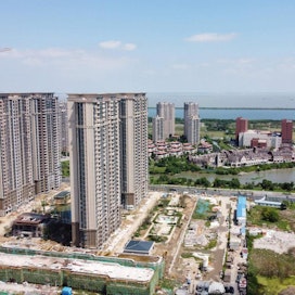 Kiinassa hiekan ja soran kysyntä lisääntyy. Betonia ja asfalttia tarvitaan, kun kaupungit laajentuvat ja uusia moottoriteitä sekä luotijunaratoja rakennetaan. Lehtikuva/AFP