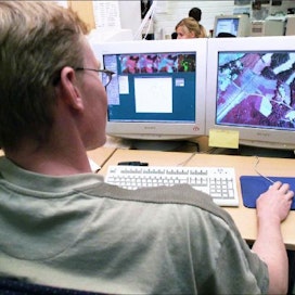 Maanmittauslaitoksen tarkastaja Petri Matintalo määritteli vuonna 2002 kasvulohkojen pinta-aloja ja viljelykasveja satelliitti- ja ilmakuvista. Vasemmalla kuvaruudulla näkyy kolme satelliittikuvaa, luokituskuva sekä peltolohkojen reunaviivat. Oikealla ruudulla on ilmakuva. Kari Salonen
