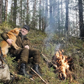 Lassi Karhapää ja Lari nauttivat keskipäivän lepotauosta tulilla.