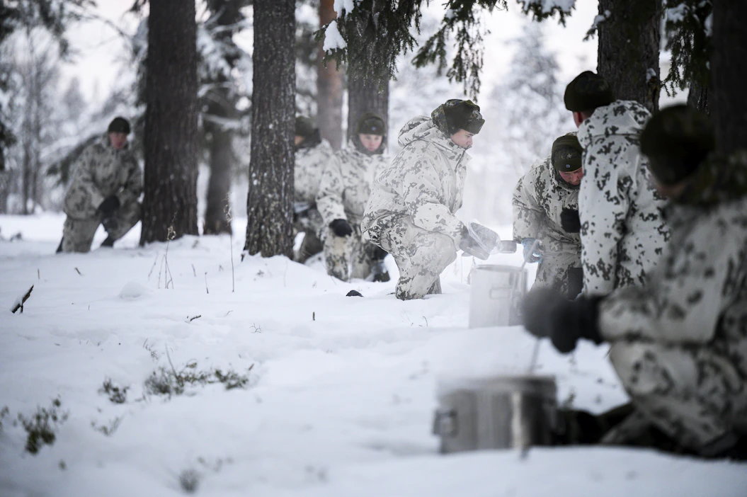 Varusmiehet jonottivat nakkikeitolle varoetäisyyksin. Yhdessä rykelmässä ei saa olla, koska ryhmä olisi silloin helppo havaita ilmasta käsin.
