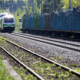 Matkustajajuna ohittaa puutavaravaunuja vetävän junan Otavan asemalla Mikkelissä. Kuvituskuva.