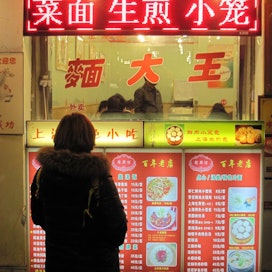 Suomalaiset ostavat muita kansainvälisiä matkailijoita useammin ruokaa katukojuista. Kuvassa koju Shanghaista.