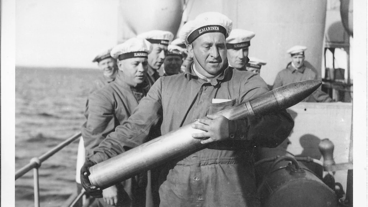 Panssarilaiva Ilmarisen tykkimies pitelee neljätuumaisen kranaattia 1930-luvulla. Kuva: Forum Marinumin kuvakokoelma.