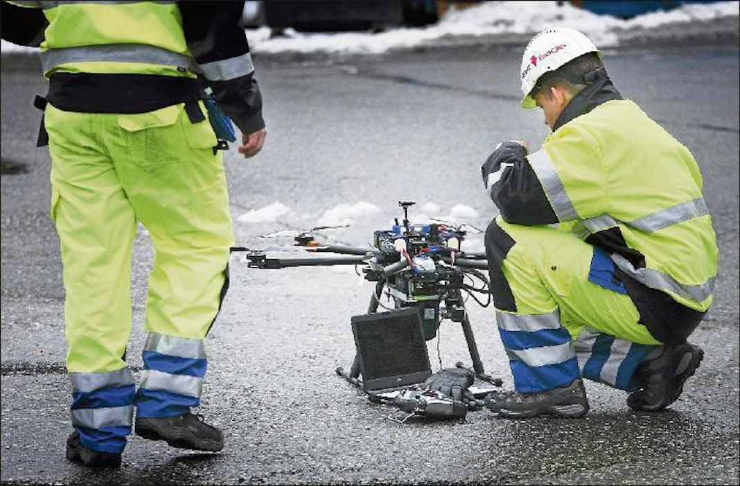 Pilotit Anttoni Jaakkola ja Atte Korhonen asettavat reitille ohjelmoidun lentorobotin lähtökuntoon. Polttomoottorilla varustetut laitteet voivat lentää kerralla kymmenen kilometriä. Lari Lievonen