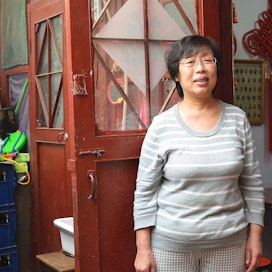 Pekingiläinen WanLing Zhao on tyytyväinen elämäänsä: nykyään on varaa syödä lihaa silloin, kun haluaa.