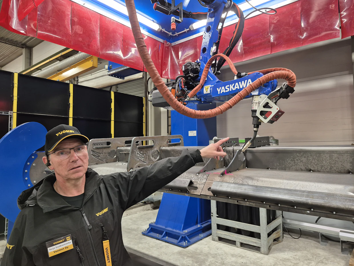 Vuomet oy:n toimitusjohtaja Reijo Vuoksenranta esittelee Yaskawa Finlandin toimittamaa tuliterää hitsausrobottia.